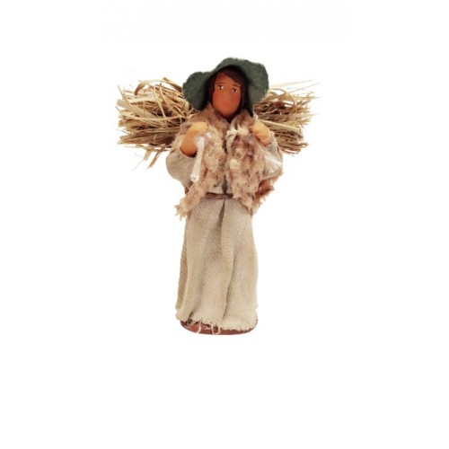 Donna con fascio di fieno sulle...